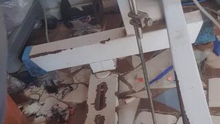 Ana sewing barefoot with both feet