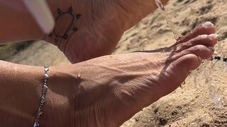 Pretty feet in the sand