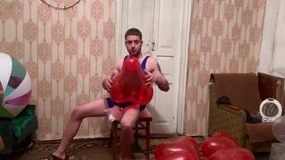 Jason sit pop heart shaped balloons