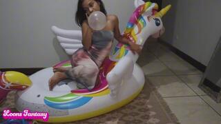 Akina blows up and pops her balloons on the unicorn