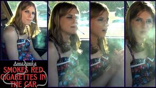 Amazonka smokes red cigarettes in the car