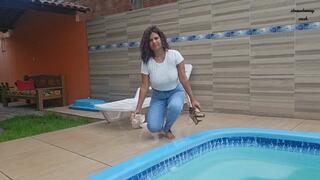 Peril in the pool in jeans, white shirt and zebra panties