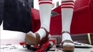 crushing RC toycar in white socks and hard soled sandals in 1000 pieces