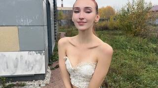 The girl poses with her shoulders in front of the camera