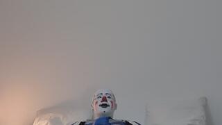 Clown in leather suit is jerking off himself