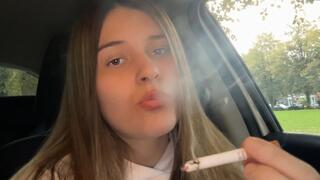 Smoking a cigarette with red lipstick