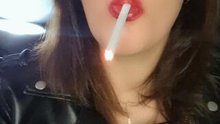 The smoky scent clings to her, mingling with the leather