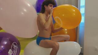 Charles blow balloons and burst giant ones