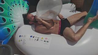 Julien blow balloons and destroy inflatable peacock