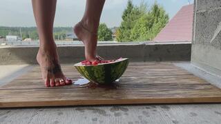 beautiful feet crushed a watermelon