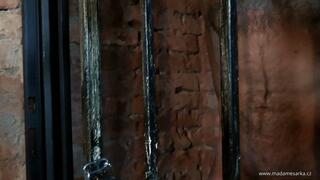 Slave in dungeon cage is beaten with Madame Sarka’s leather belt