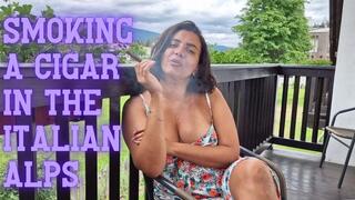 MILF sensually smokes a cigar in the Alps