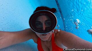 Carissa in the orange bikini in the resort pool