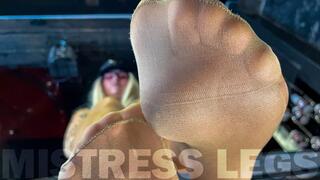 Beautiful feet of the Mistress in flesh-colored tights tease you on the table close-up (MP4 4K)