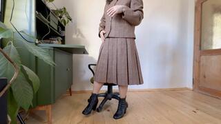 tacher in woolen costume toe tapping in leather boots