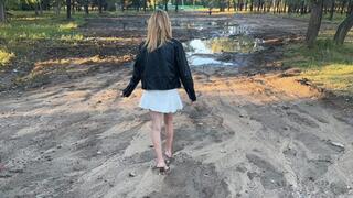 a girl in open-toed shoes walks on very dirty ground, her feet get sucked into the mud, and in one such deep puddle she loses her shoe and goes looking for it (reissue)