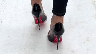Stilettos pumps on snow road, high heels in snow, high heels on ice, walking on high heels on snow