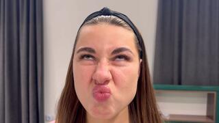 The girl tries to touch her nose with her lip, wrinkles her nose (custom video)