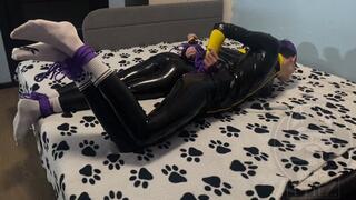 Two bound latex guys play a game of who will fall off the bed first