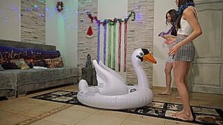 Girls popping big inflatable swan **4K**