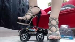 crushing a nice black monster Truck in nylons and heels