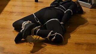 Straight superhero tied up and left to struggle on the floor