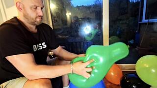 Tom hand pops a pile of under-inflated balloons