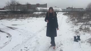 A girl in high-heeled shoes makes holes in thin ice, but her shoes sometimes fall through the ice, her feet plunge into icy water