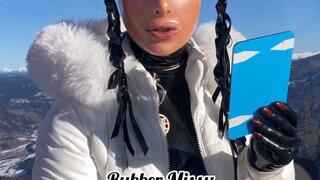 Rubbermissy dressed in full latex and latex mask in ski gondel doing last lipstick finish