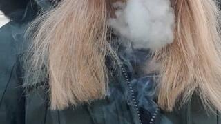 Smoking a cigarette outside with my green jacket