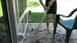 Lilly sweeping the porch barefooted