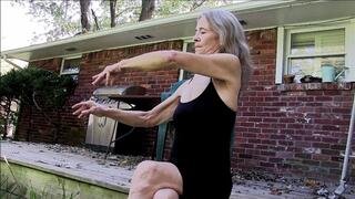 Lilly sitting on the deck, running her fingers through her long granny hair