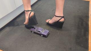 Giantess Raven Lee crushes a 1970 Plymouth GTX toy car in sexy black wedges with painted toenails high right view