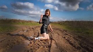 Muddy knee high white socks and black stockings, white socks on muddy field, wet white sock