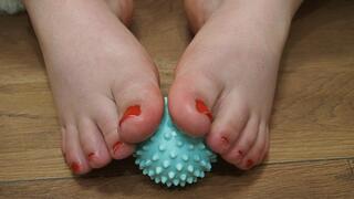 Playing with toes with a massage ball