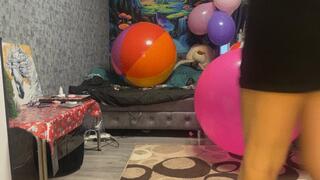 Girl riding on pink beachball in sneakers