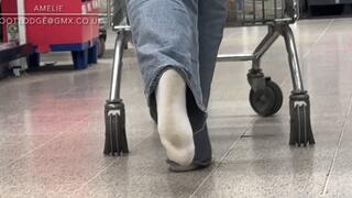 Naughty Amelie gets her white socks dirty walking around the grocery store having forgot to wear shoes