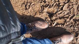 RUBBING BOOTS IN THE MUD AND GRASS