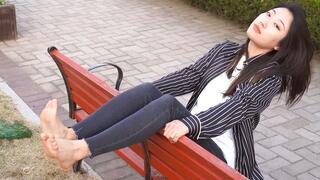 WL - Naughty girl takes off her white socks and shows her bare feet on the bench