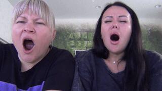 Blonde and brunette yawn widely b