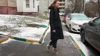 A girl in beautiful high-heeled sandals and nylon stockings likes to have fun with the pedals of a car