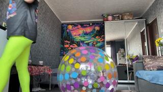 Girl in leggings riding on intex dotted beachball