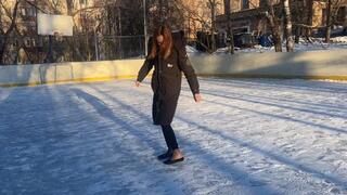 A girl in ballet flats walks on very slippery ice and constantly falls, losing her ballet shoes