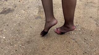 Girl in nylon stockings walk on muddy slippery road, she crushing her stockings, make them dirty, ripped and untidy