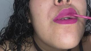 Sensual, fleshy lips playing with a lollipop