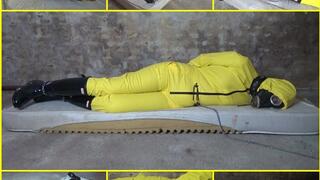 Handcuffed captive woman in a yellow rain overalls with gas mask