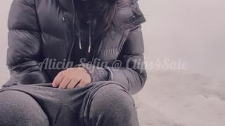 Squatting and peeing in a parking lot of a mall