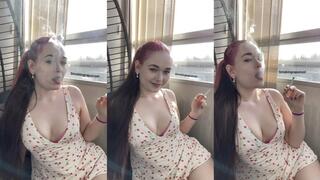 Smoking in a cherry dress with cleavage, visible smoke with the sun behind me - Smokingrapunzel