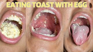Eating toast with scrambled eggs