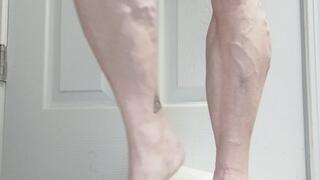 Tempest stands flexing and using toy with oiled legs